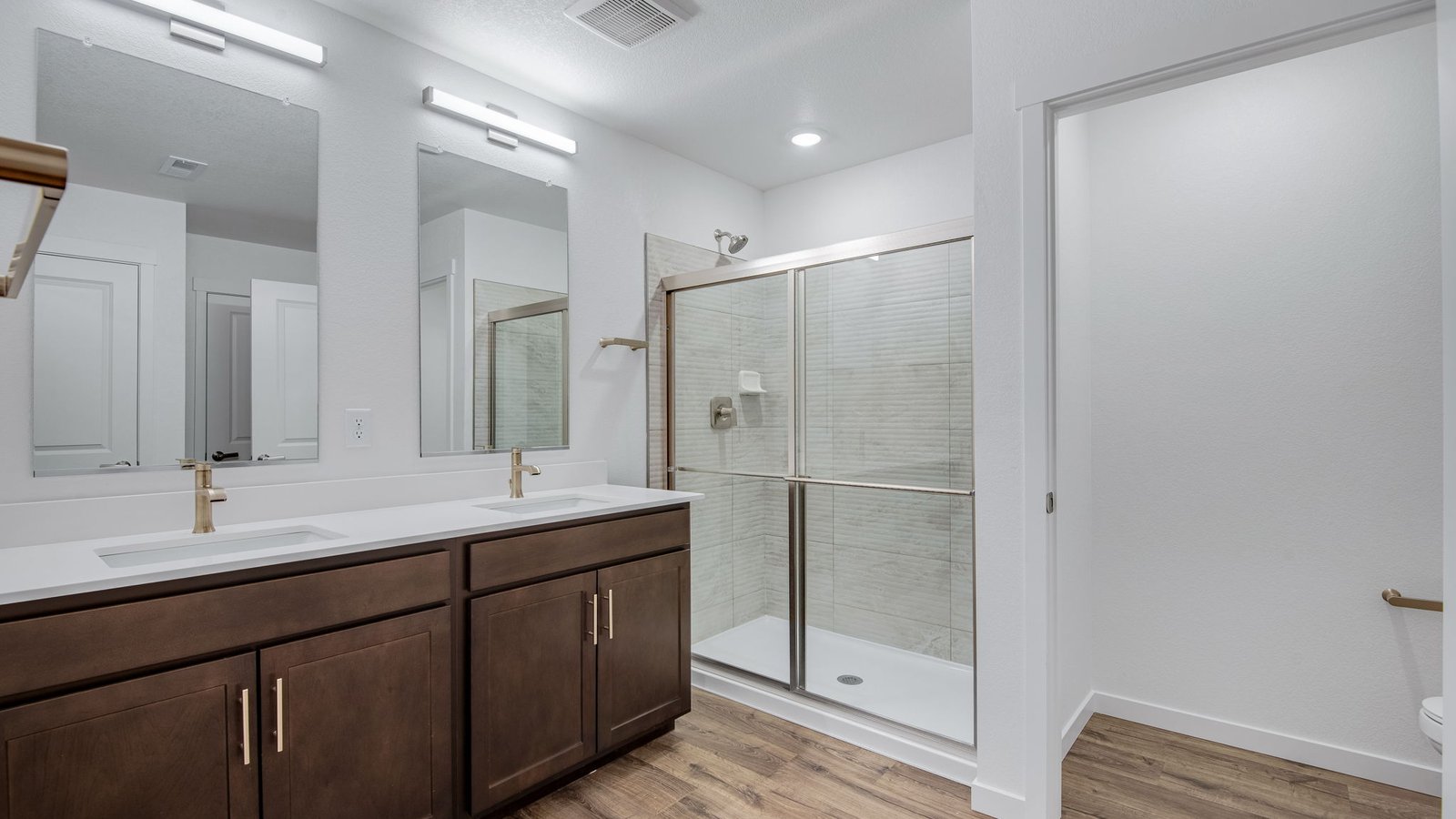 Attached private primary bathroom in new home conveniently located at Trails at Crowfoot Community