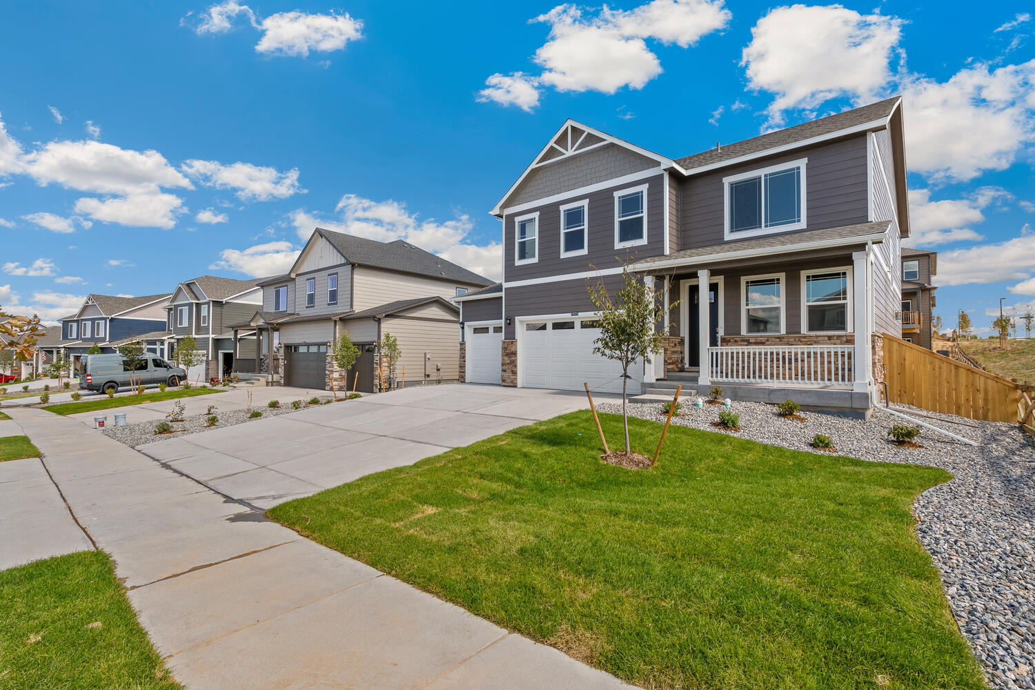 View down street of Bridgeport two-story 3-car home