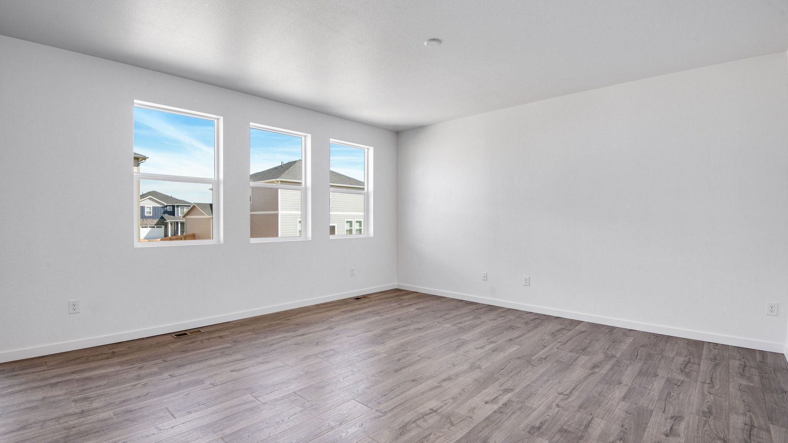 Living room with large windows in new home community in Parker Colorado
