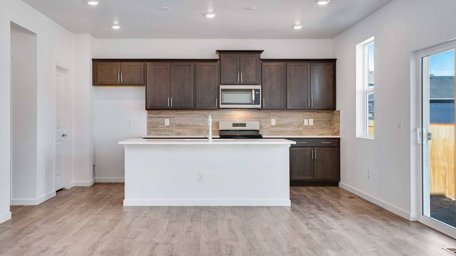Spacious kitchen with espresso new finishes in trails at crowfoot in Parker Colorado