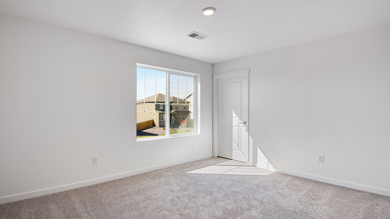 Secondary bedroom with large windows in new trails at crowfoot community