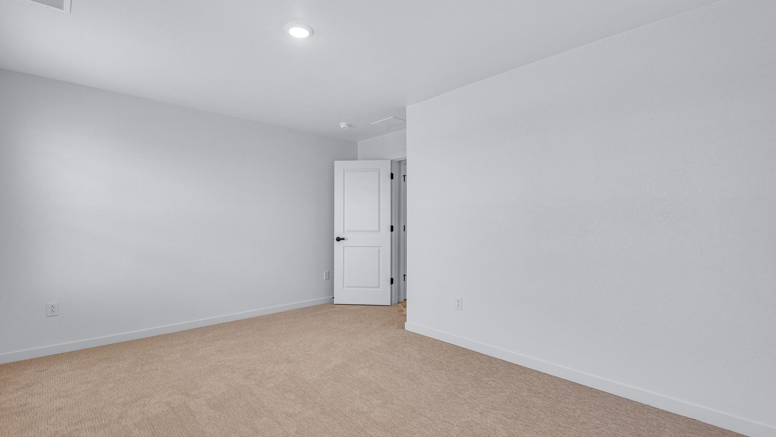 Secondary bedroom with natural light and versatile layout.