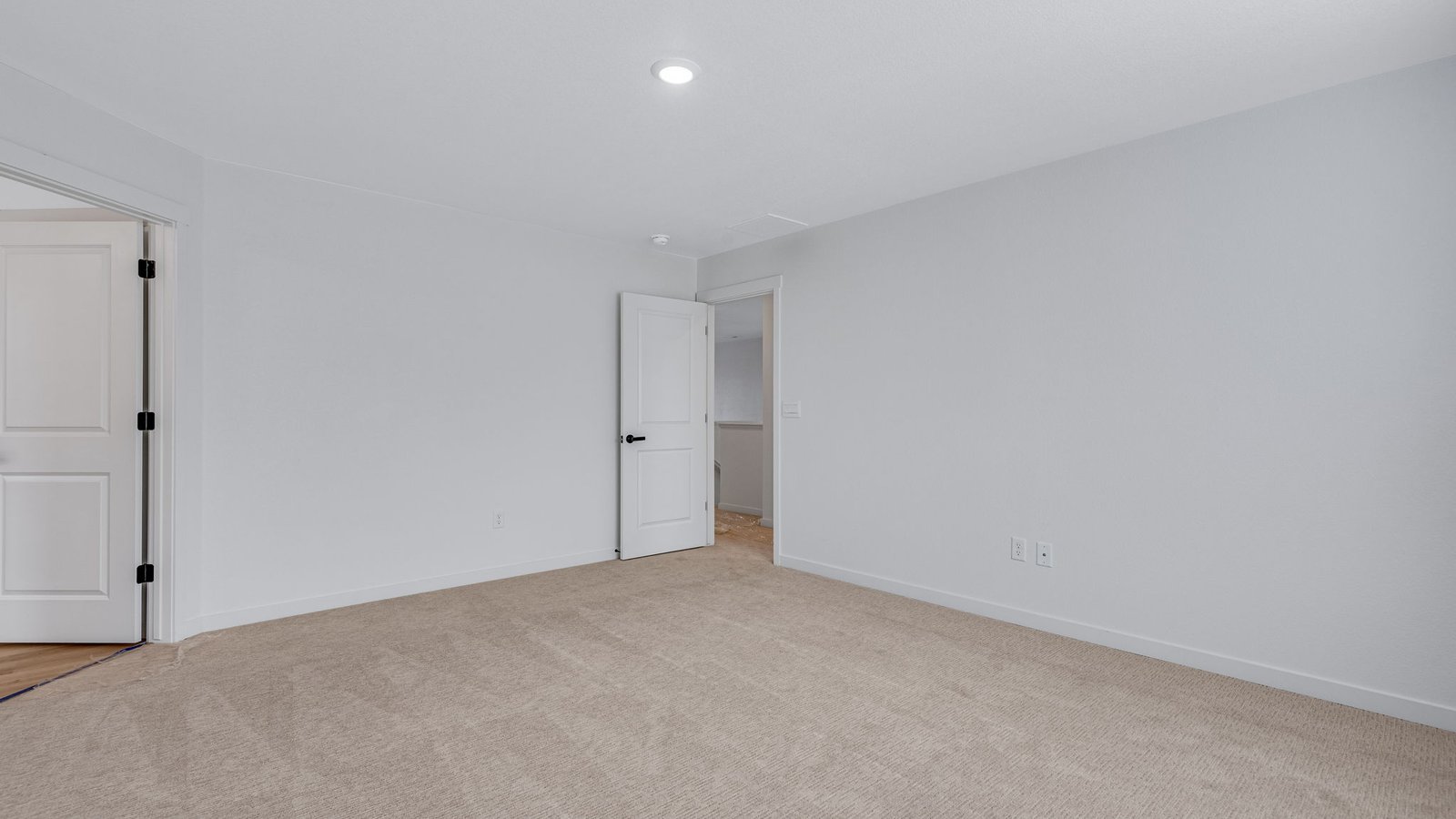 Spacious owner’s suite designed for comfort with natural light and neutral finishes.