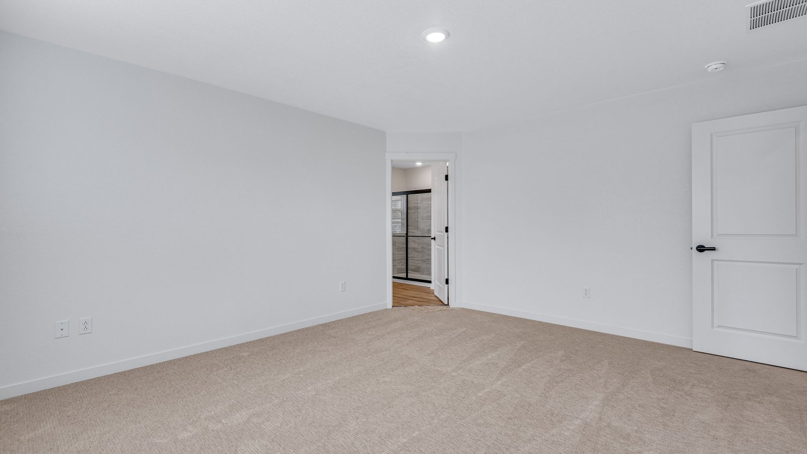 Primary bedroom in Bridgeport home with large windows and relaxing atmosphere.