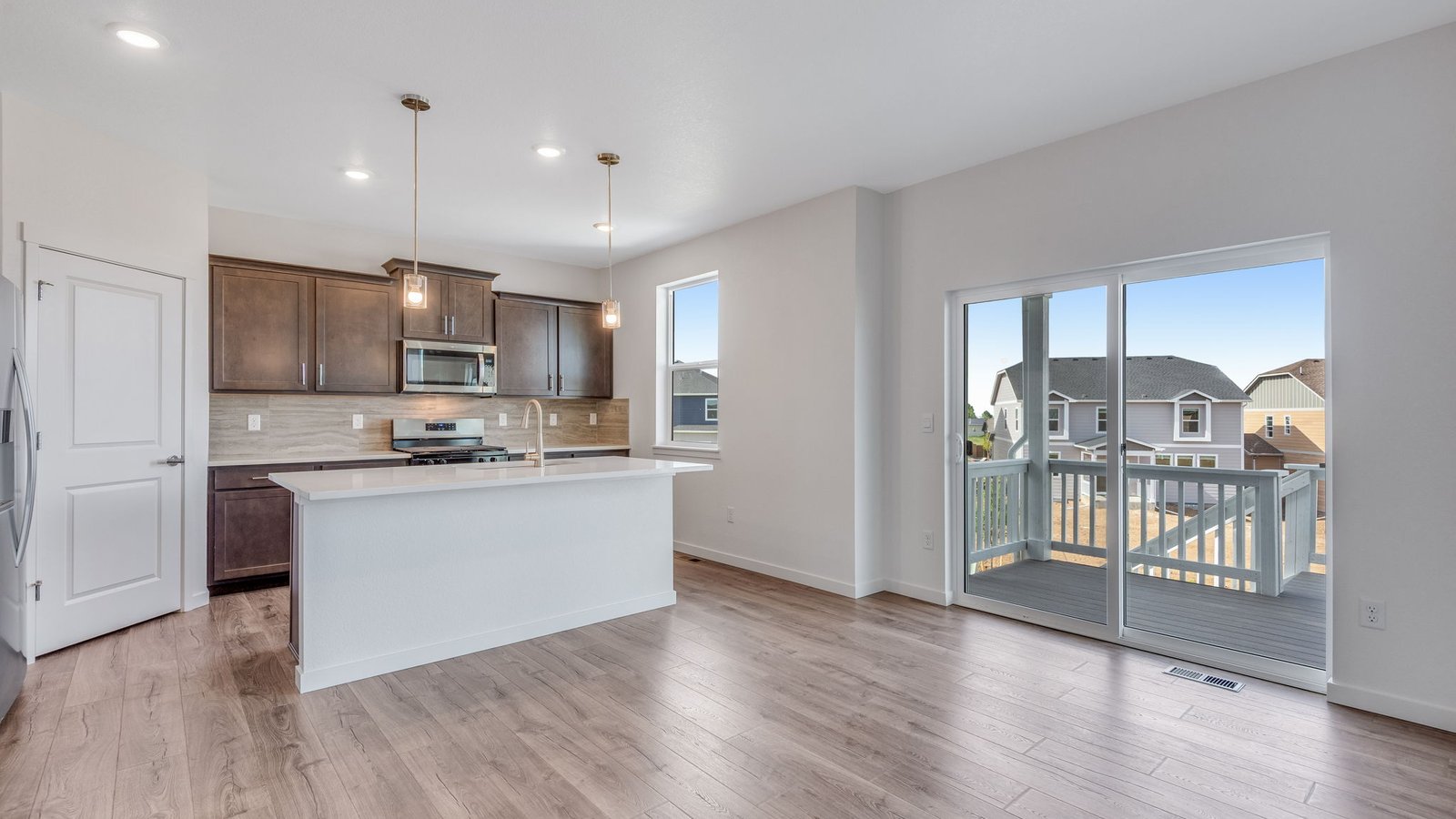 Kitchen with sliding door access to backyard in new Parker, Colorado home