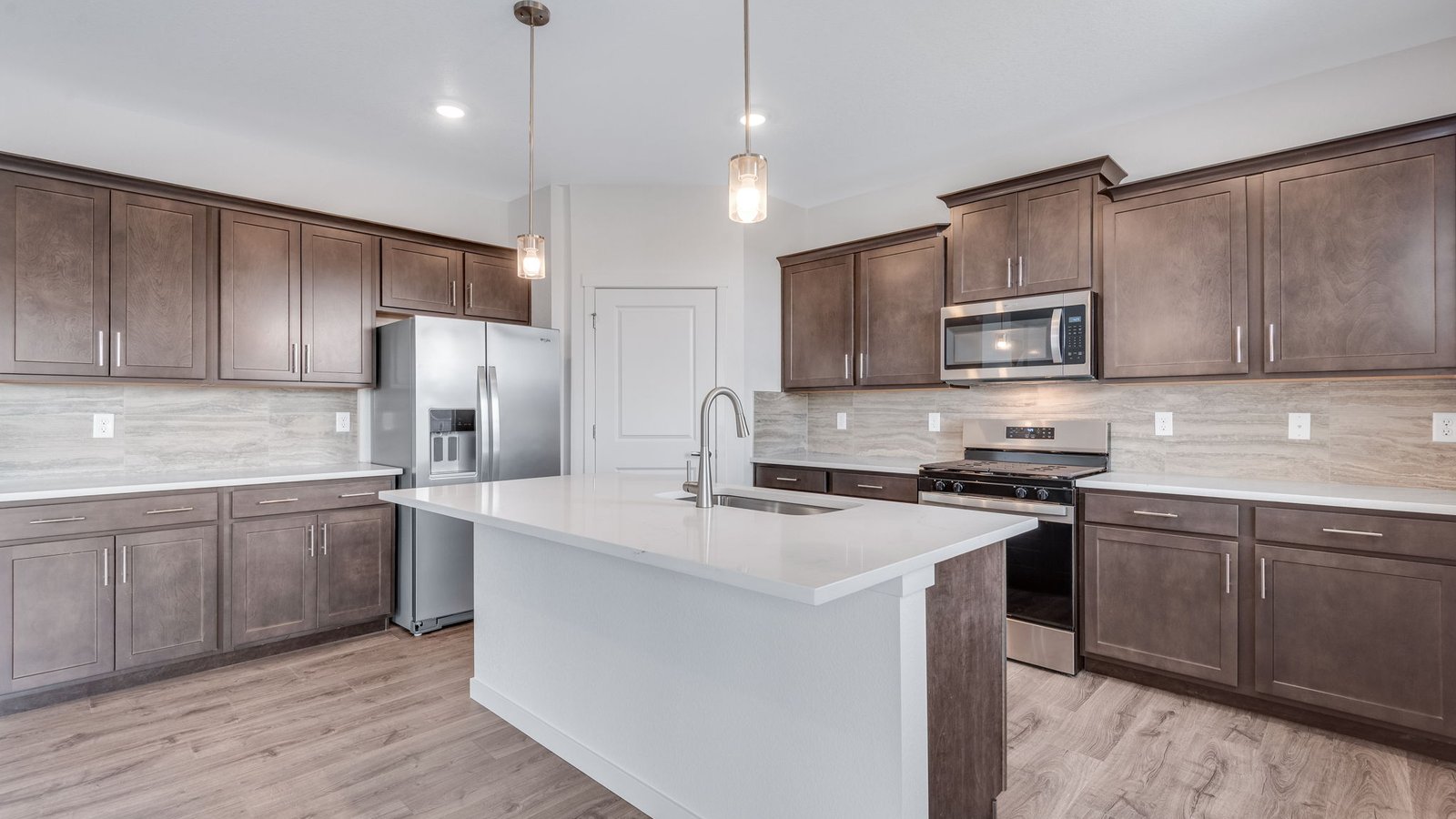 Spacious kitchen with modern espresso cabinets in new D.R. Horton home in Parker, Colorado