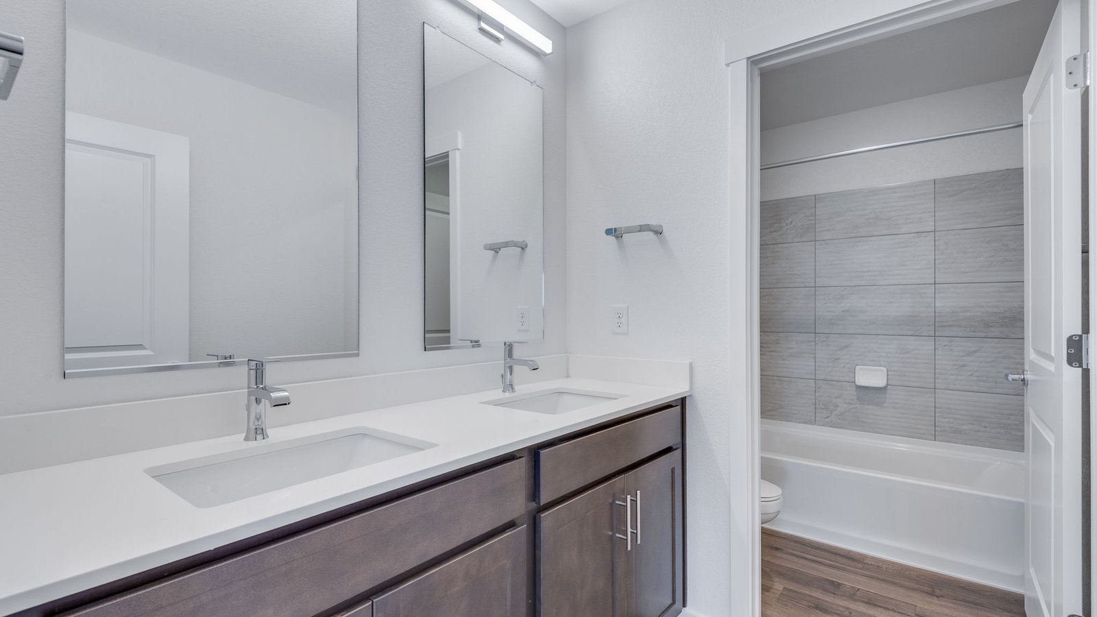 Spacious Secondary bathroom with dual vanity sinks in new D.R. Horton home in Parker, Colorado