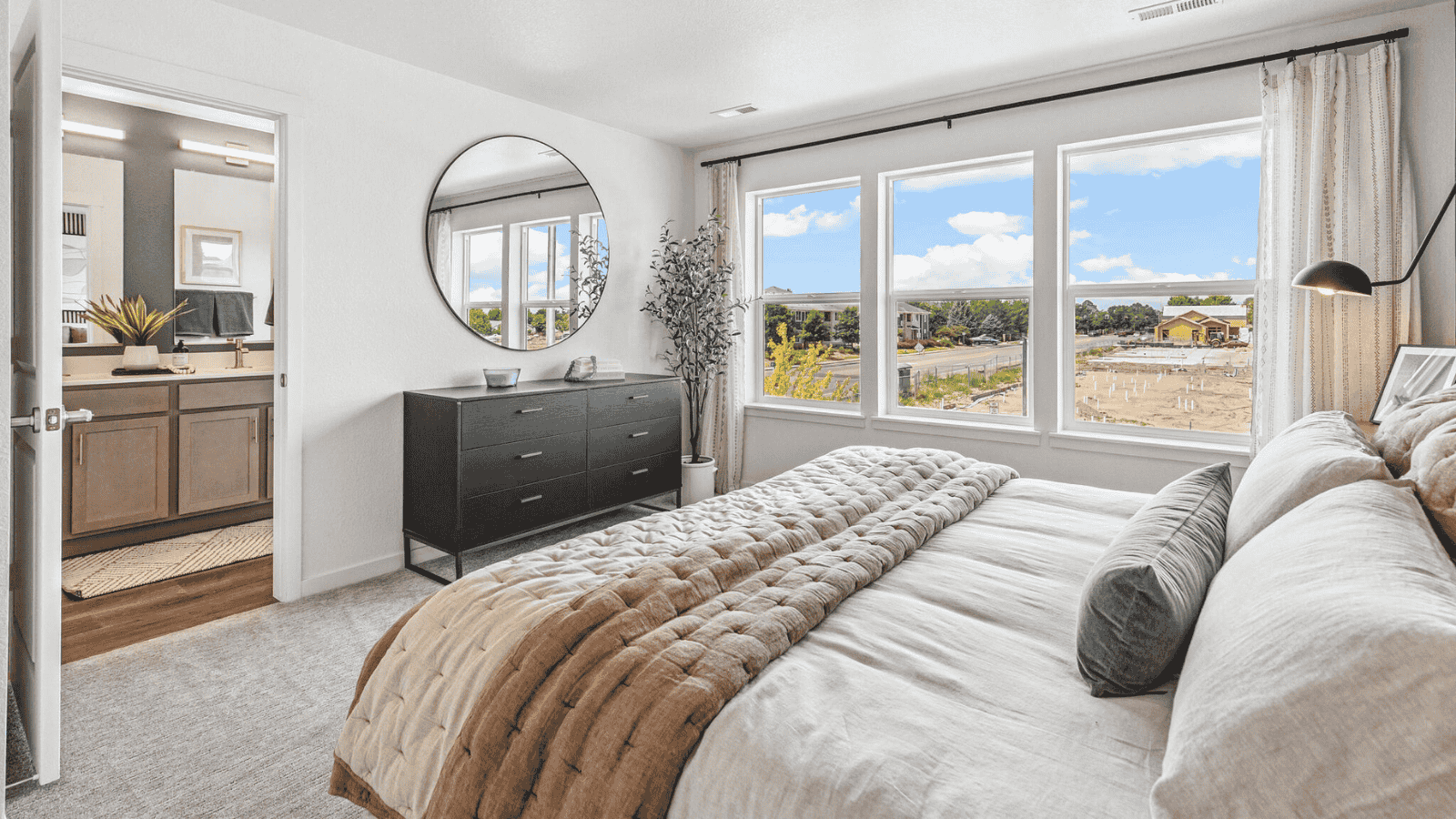 Spacious primary bedroom with large windows in new D.R. Horton home in Arcadia community in Denver