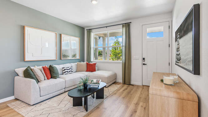 Melbourne wide angle view of living space in furnished model home displaying entry door