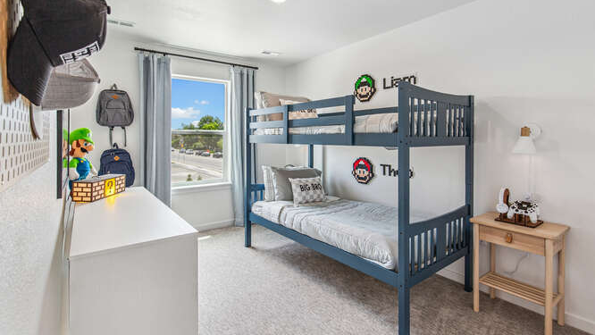 Furnished Muirfield model home secondary bedroom with 1 operable window.