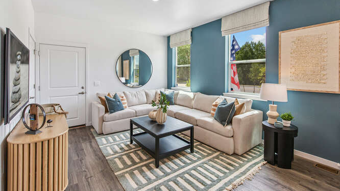 Muirfield furnished model home great room with laminate hardwood flooring and dual operable windows