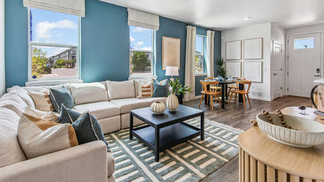 Muirfield model wide angle view of dining, kitchen of furnished model home displaying contemporary LED light fixtures