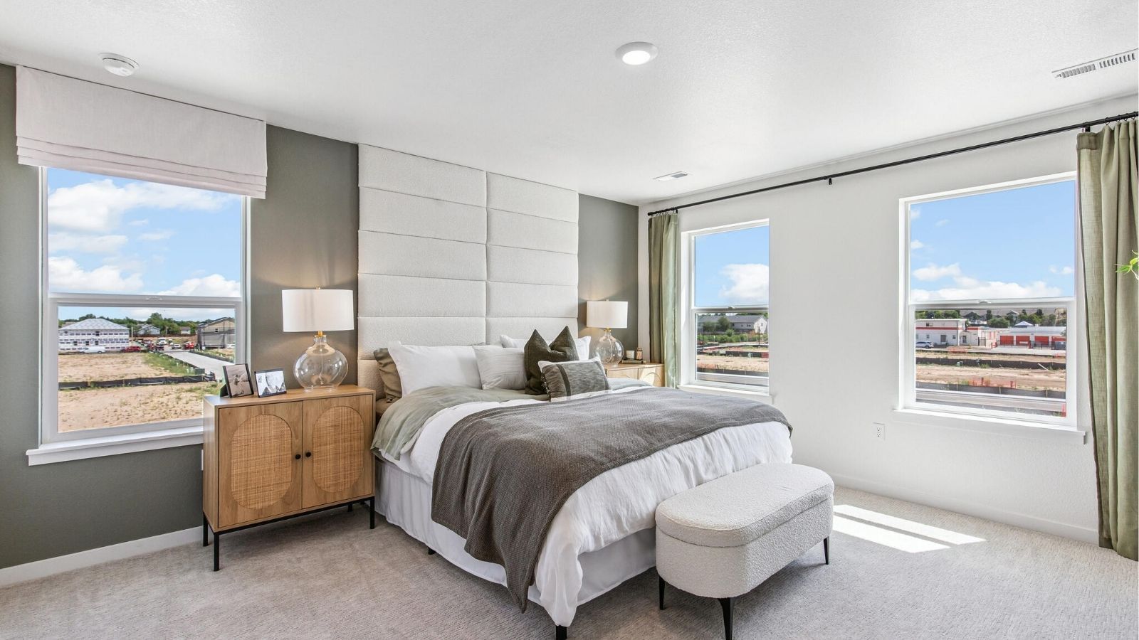 primary bedroom with large windows in new construction home by d.r. horton denver, co