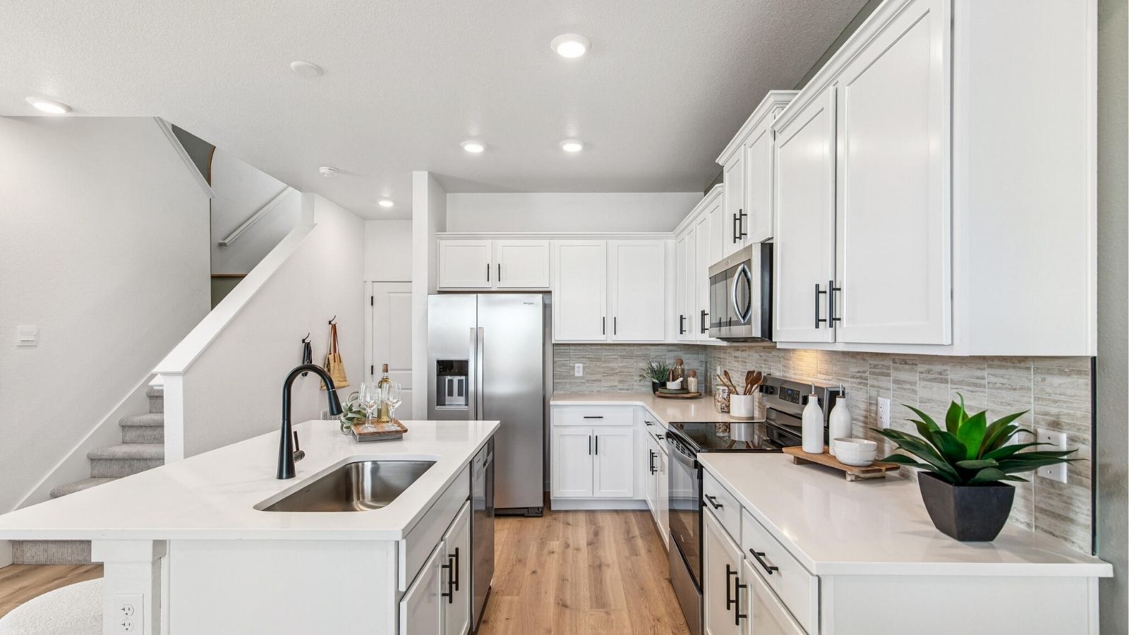 kitchen with white cabinets and black hardware in new d.r. horton home Denver, CO
