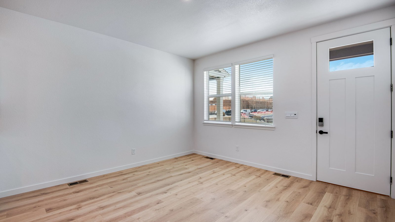 front door and living room of new townhome by D.R. Horton Denver, CO