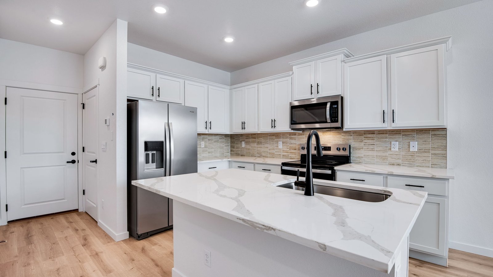 kitchen with large island in new townhome by D.R. Horton Denver, CO