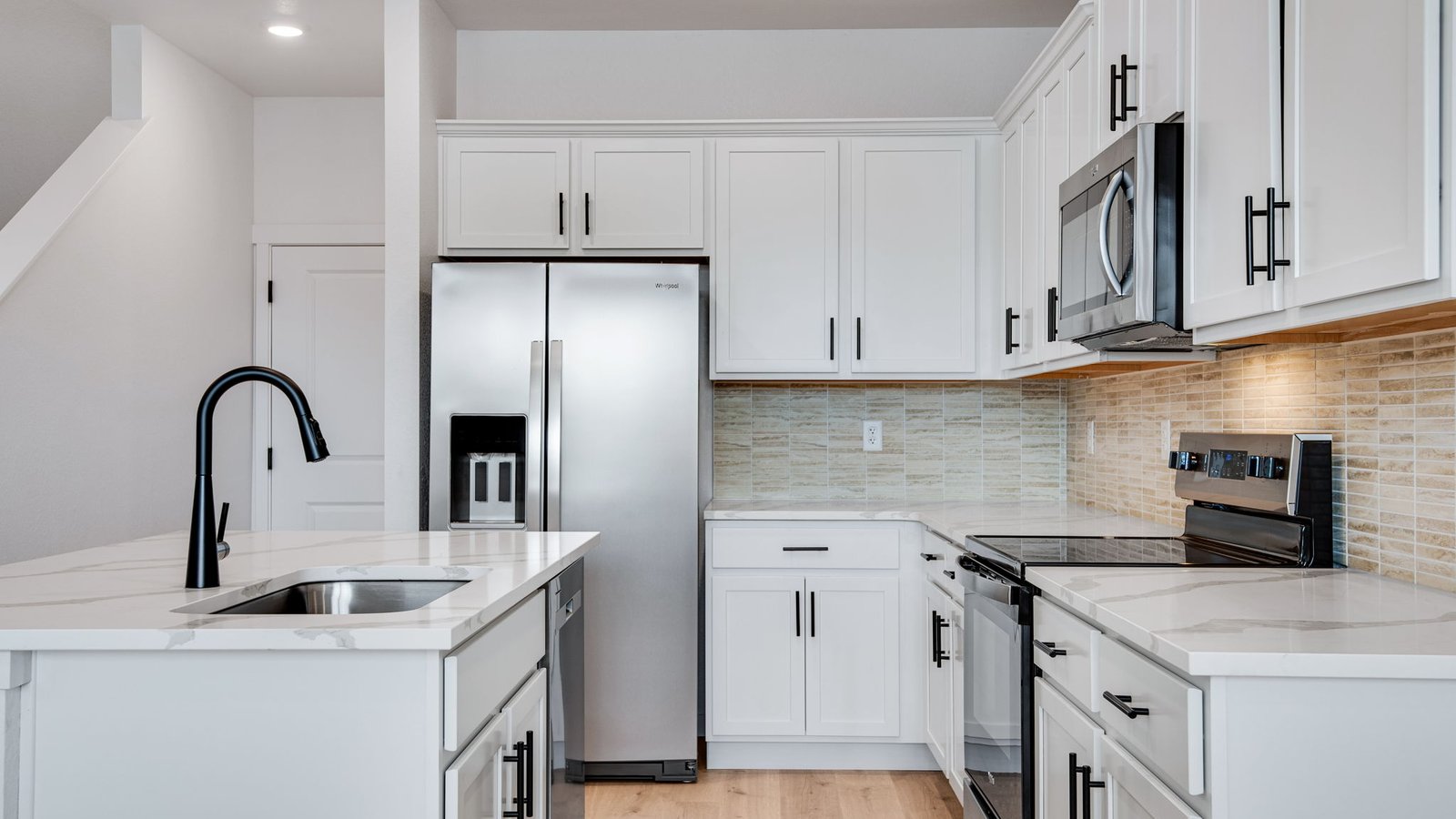 kitchen with stainless steel appliances in new home by D.R. Horton