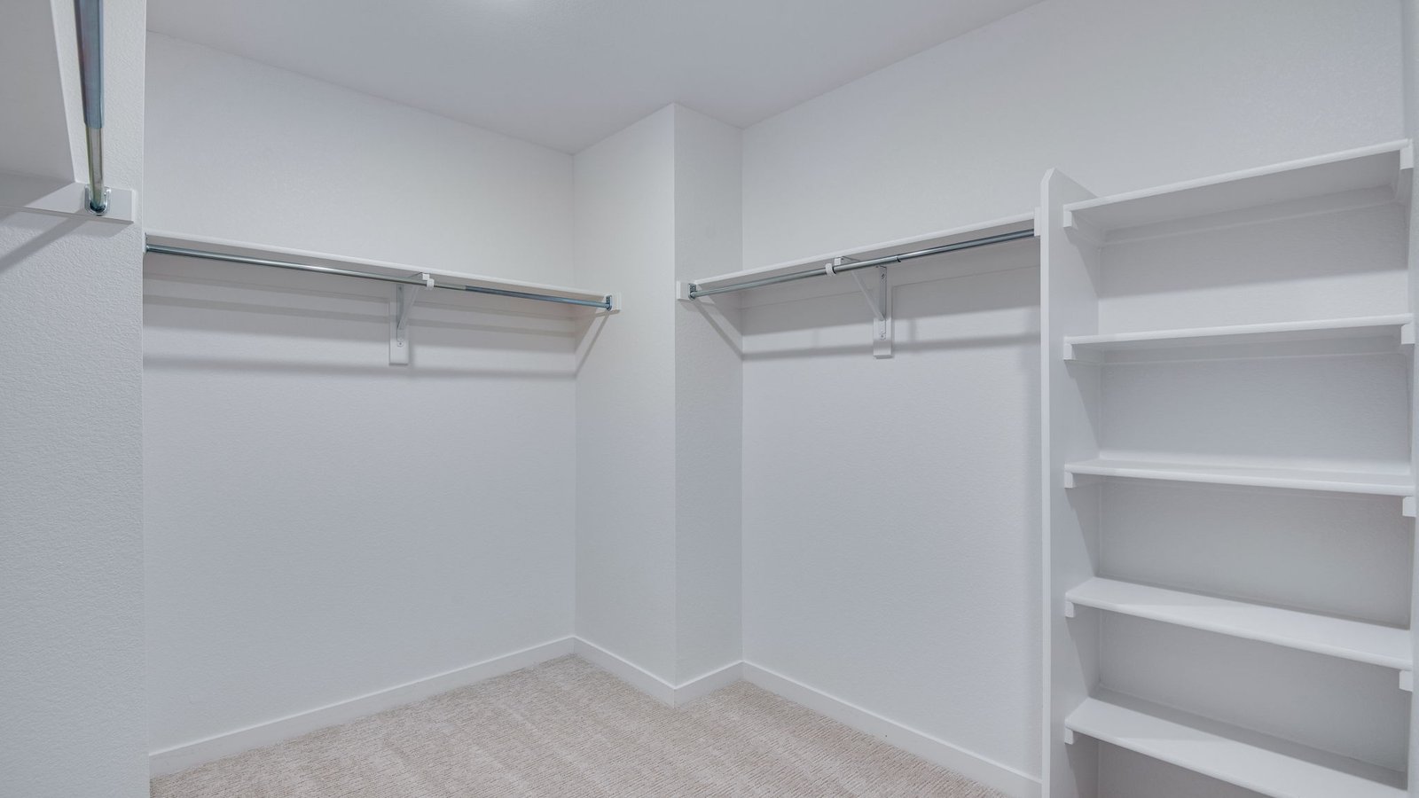 large primary walk in closet in new construction home by D.R. Horton