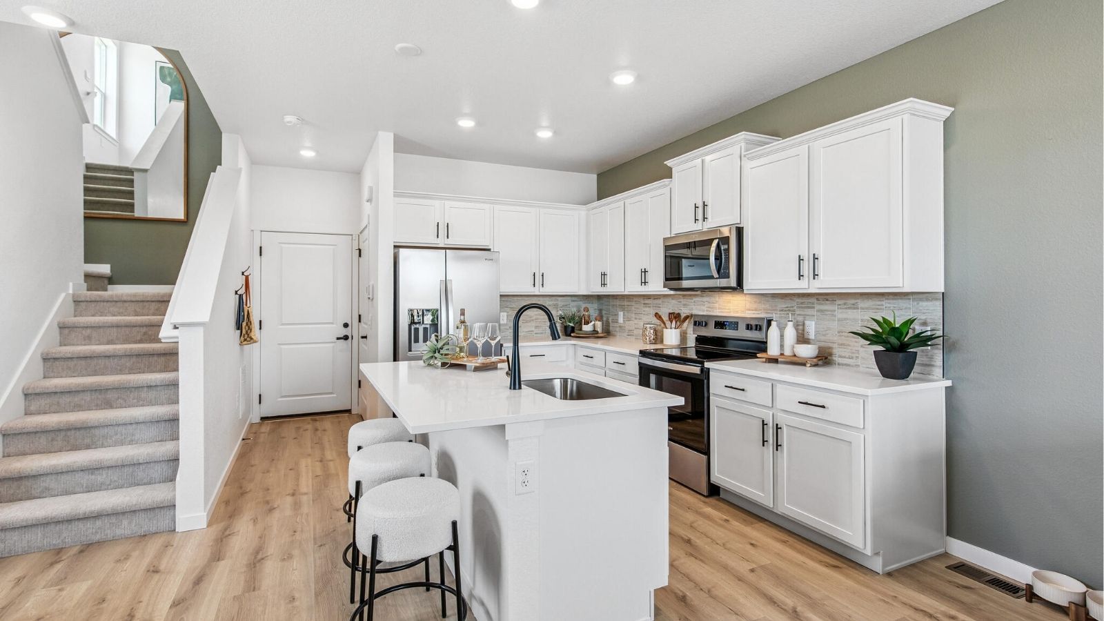 kitchen and stairs leading to second floor of new construction townhome in Denver, CO