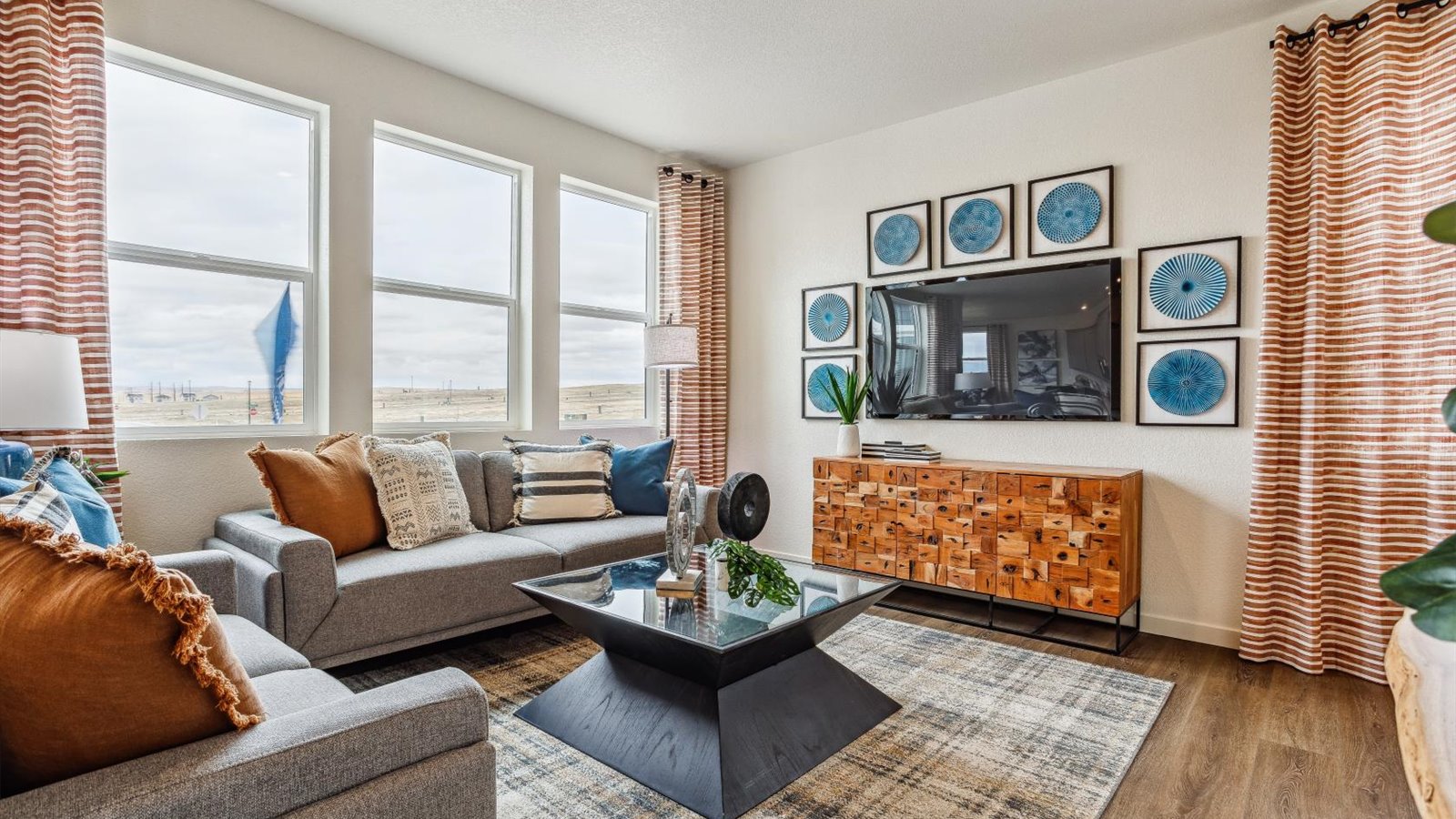 Inviting living room with large windows and hardwood flooring