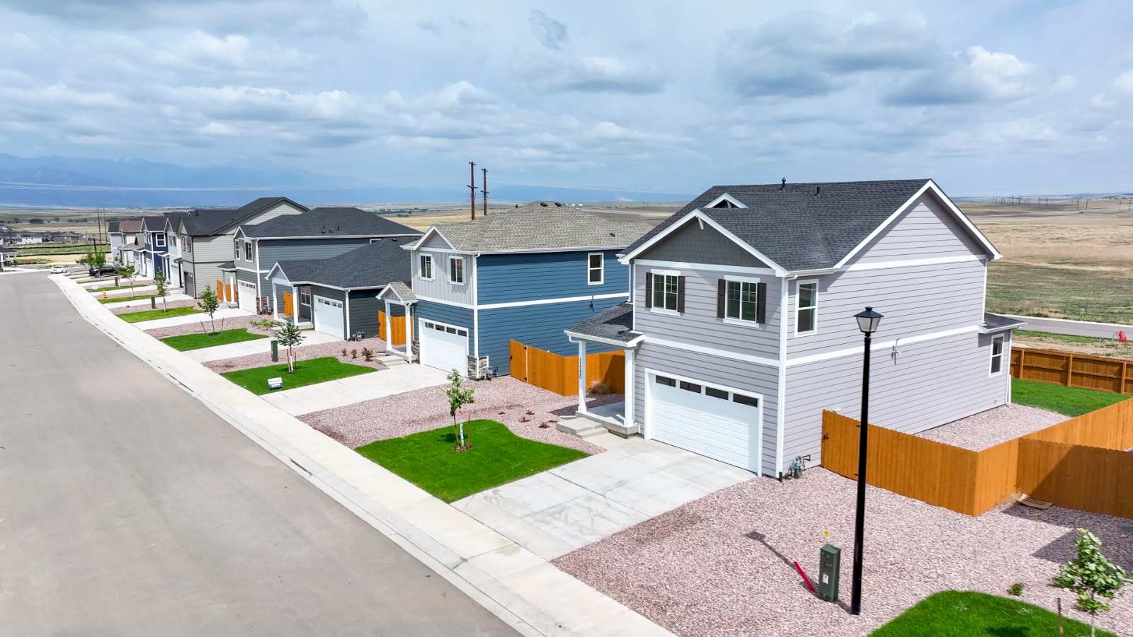 Angled view of two-story homes showing low maintenance landscaped front yard