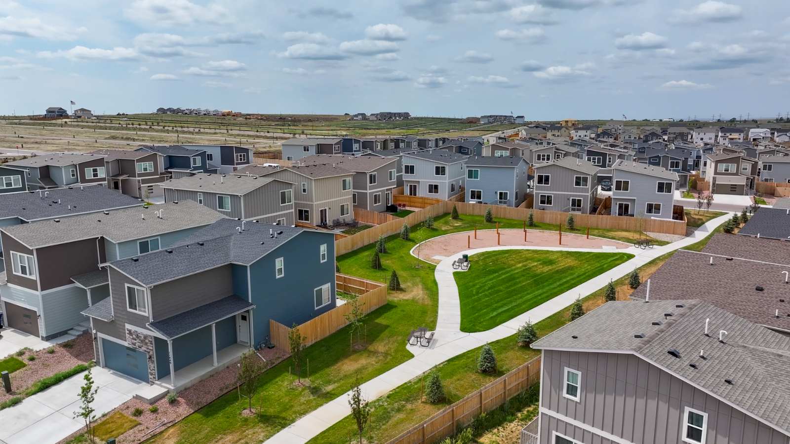 New Homes in Lorson Ranch community surrounding treelined greenspace with picnic tables