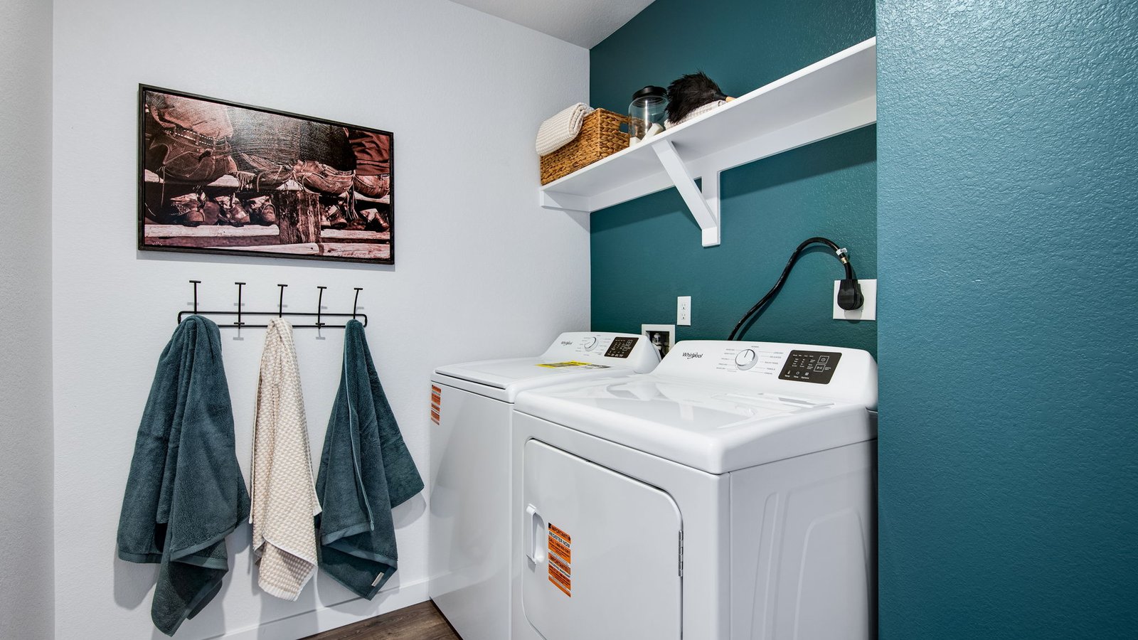 Convenient laundry room in the Osprey floor plan with dedicated washer and dryer space and functional layout.