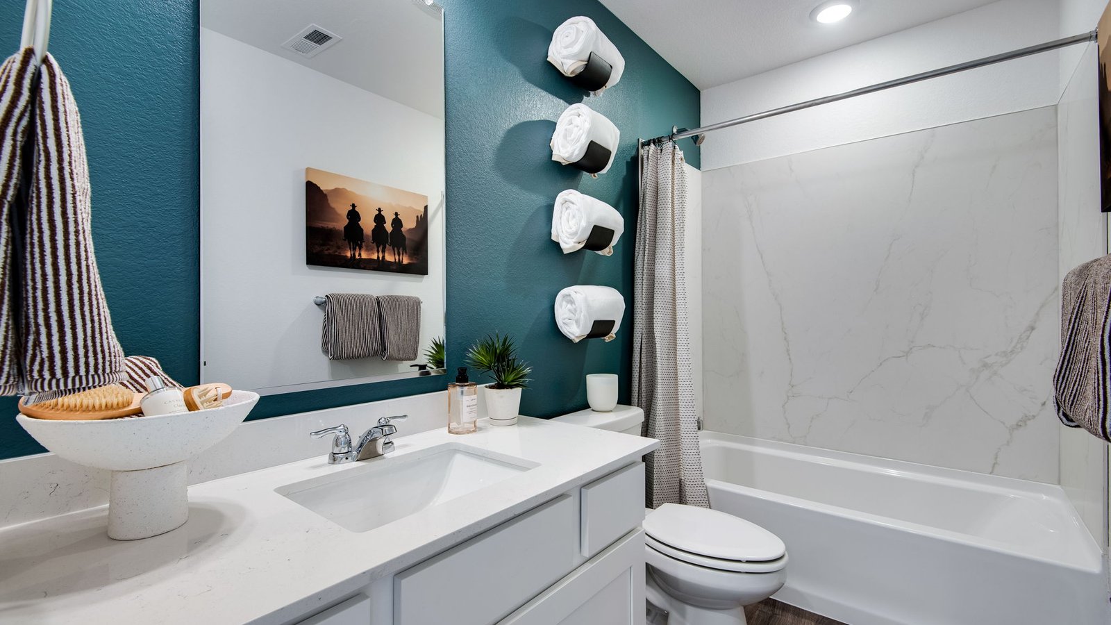 Full secondary bathroom in the Osprey floor plan with a shower/tub combination and clean, modern finishes.