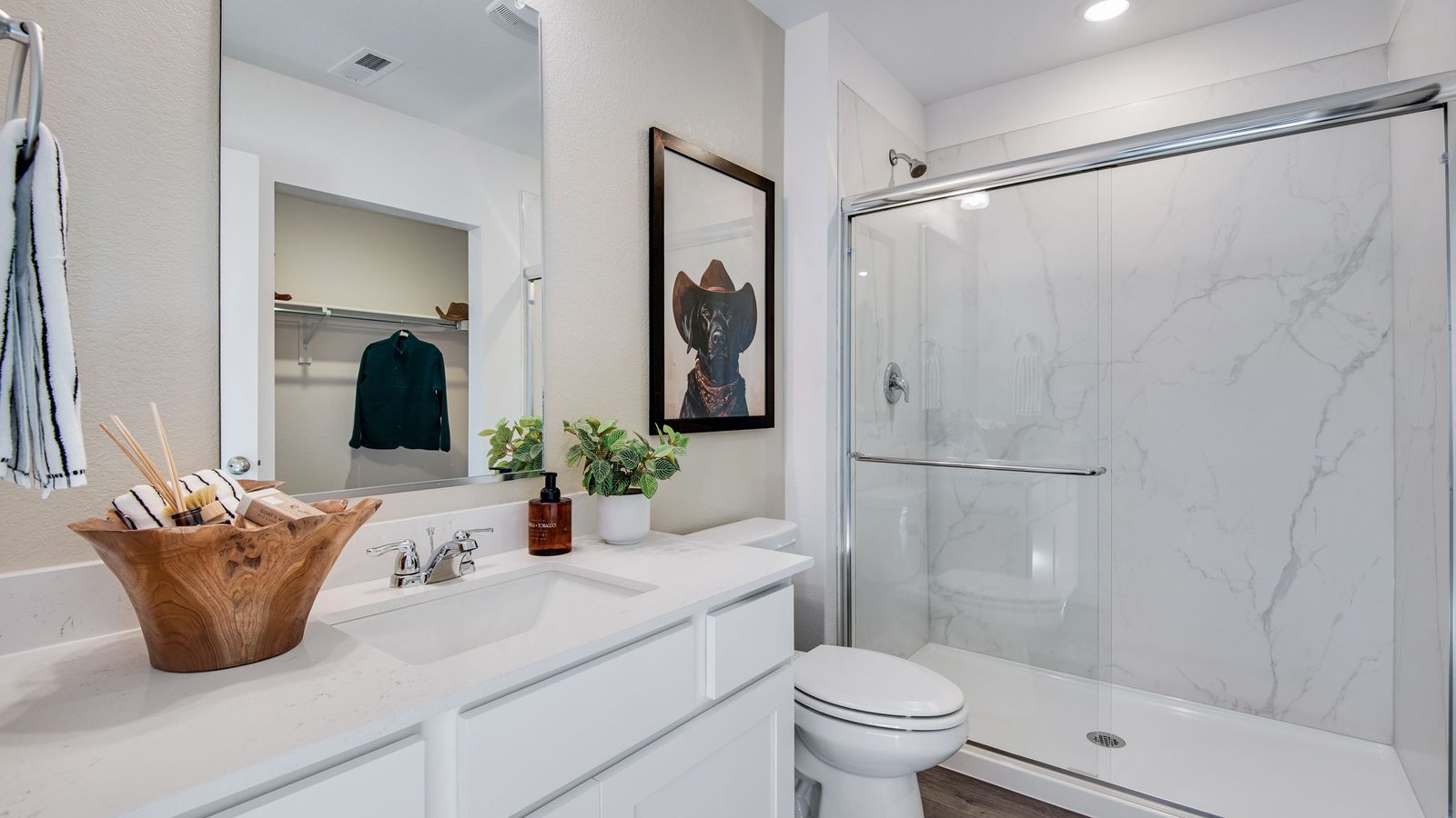 Primary bathroom in the Osprey floor plan with dual sinks, modern finishes, and a walk-in shower.