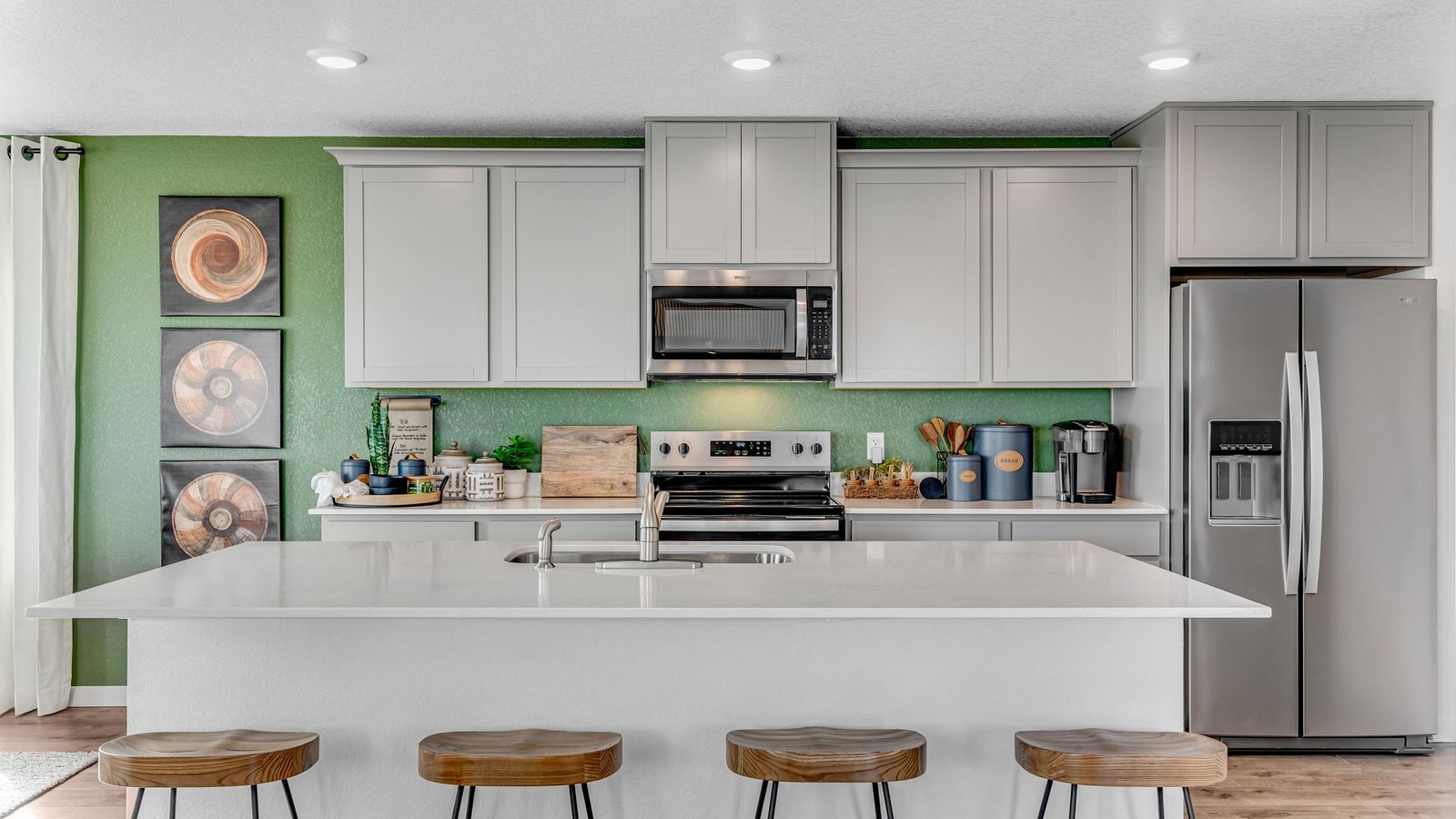 Stylish kitchen with spacious island, sleek countertops, and modern cabinetry in the Edmon home.