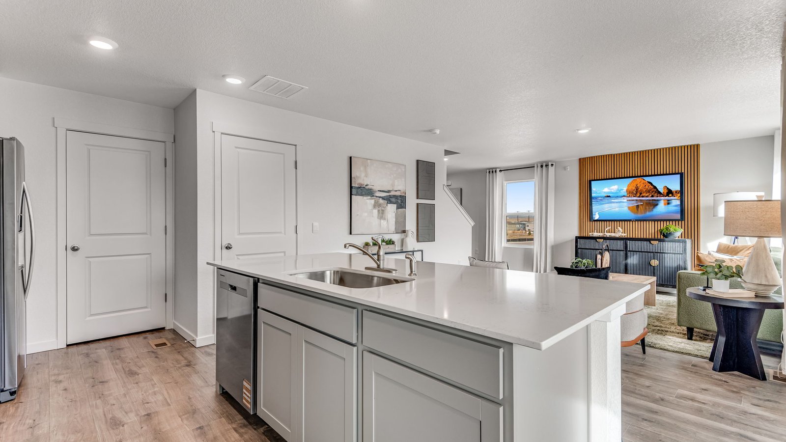 Open-concept kitchen featuring stainless steel appliances, ample storage, and center island seating.