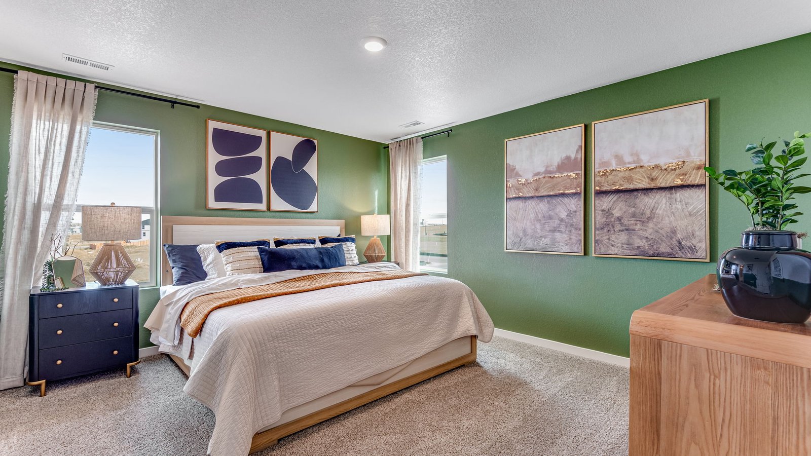 Spacious primary bedroom with large windows, soft natural light, and comfortable layout.