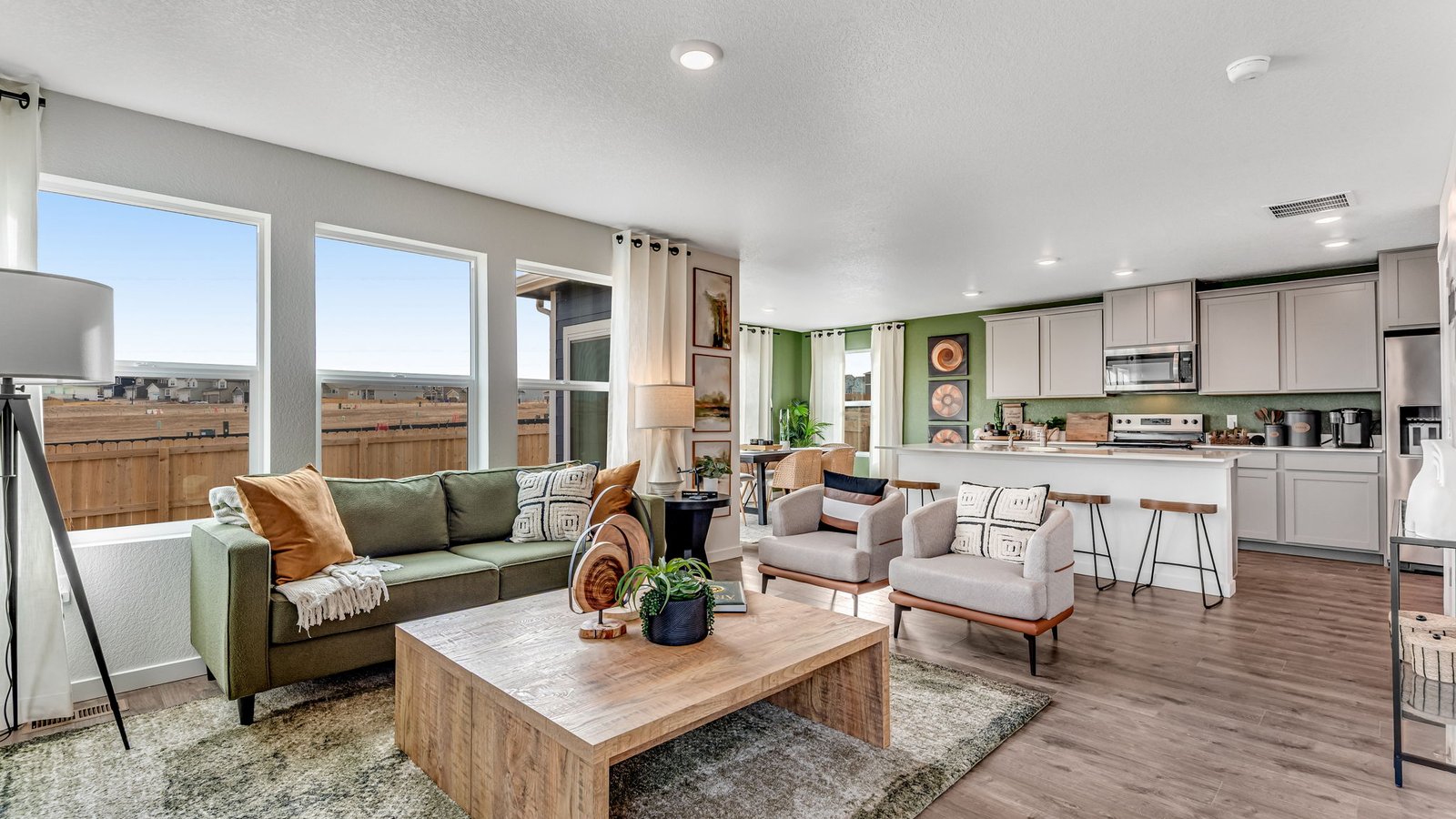 Spacious great room in the Edmon floor plan with large windows, natural light, and open-concept flow