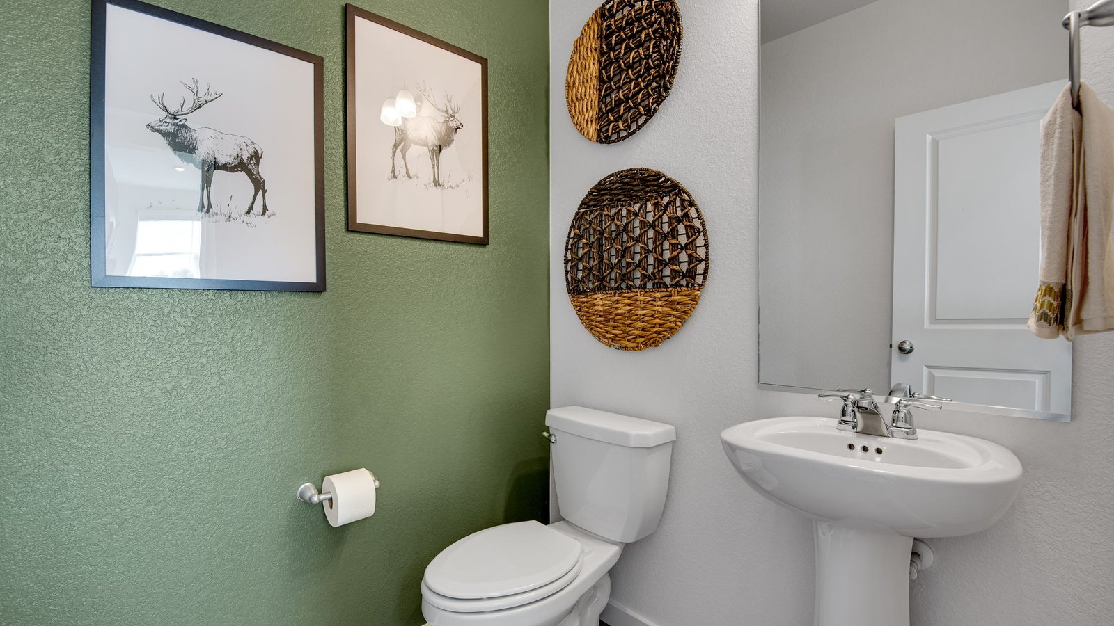 powder bath with green accent walls in model home by d.r. horton
