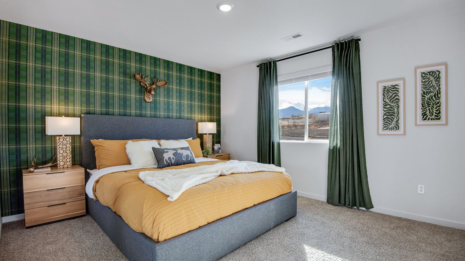 Spacious primary bedroom with large windows in new D.R. Horton home near downtown Colorado Springs