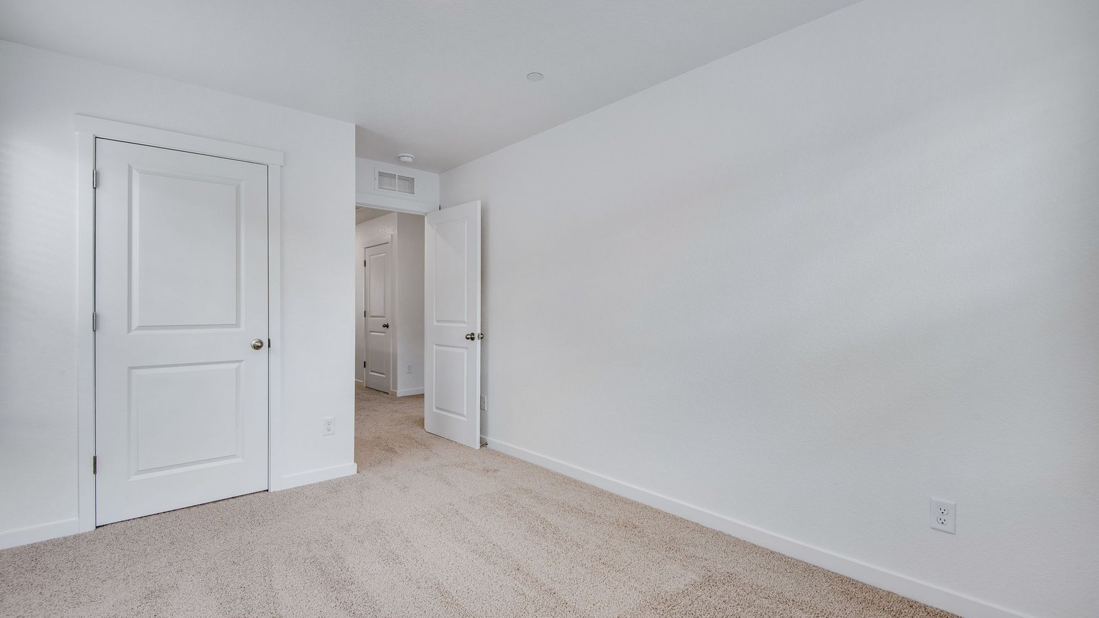 Secondary bedroom with spacious closets in new home at Settler's Crossing