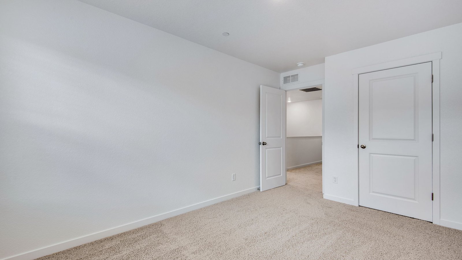 Secondary bedroom with spacious closets in new home at Settler's Crossing