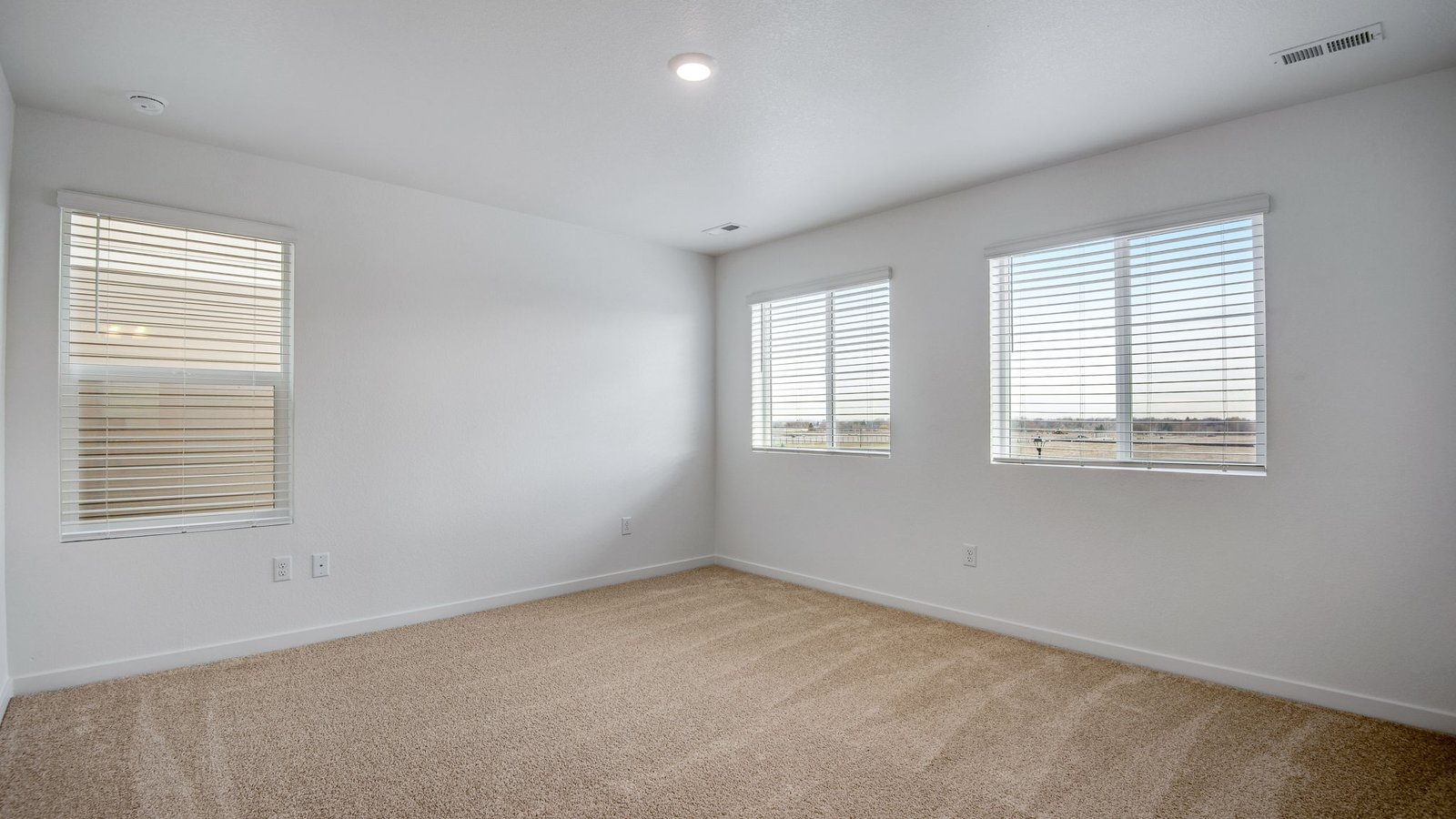 Spacious primary bedroom of new home in Commerce City Colorado