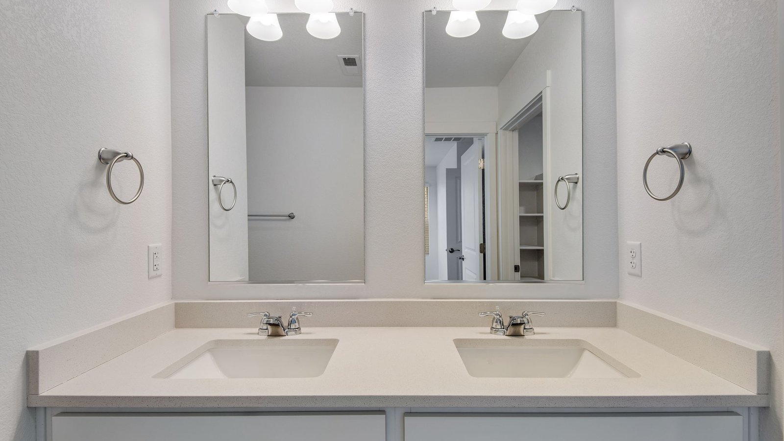Attached private primary bathroom with dual vanity sink in new home in Commerce City Colorado