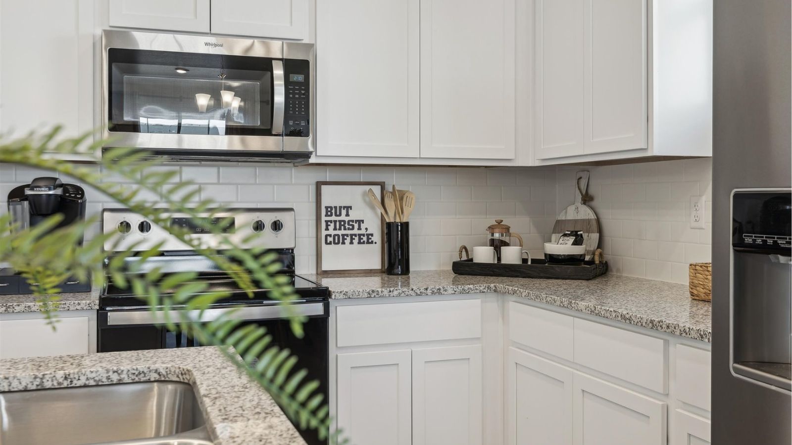 kitchen with white cabinets and new appliances
