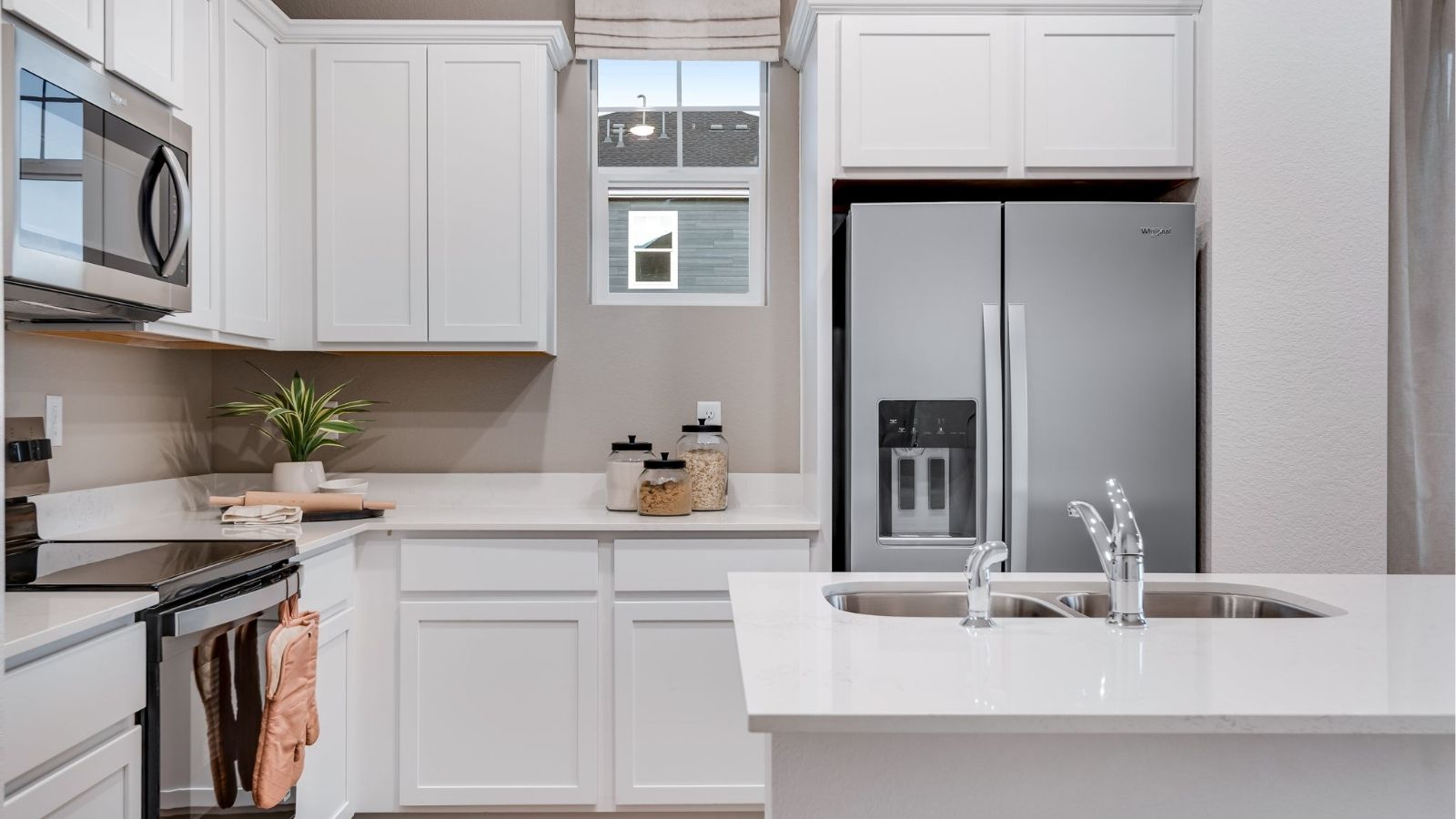 Kitchen with eat‑in island in D.R. Horton paired home