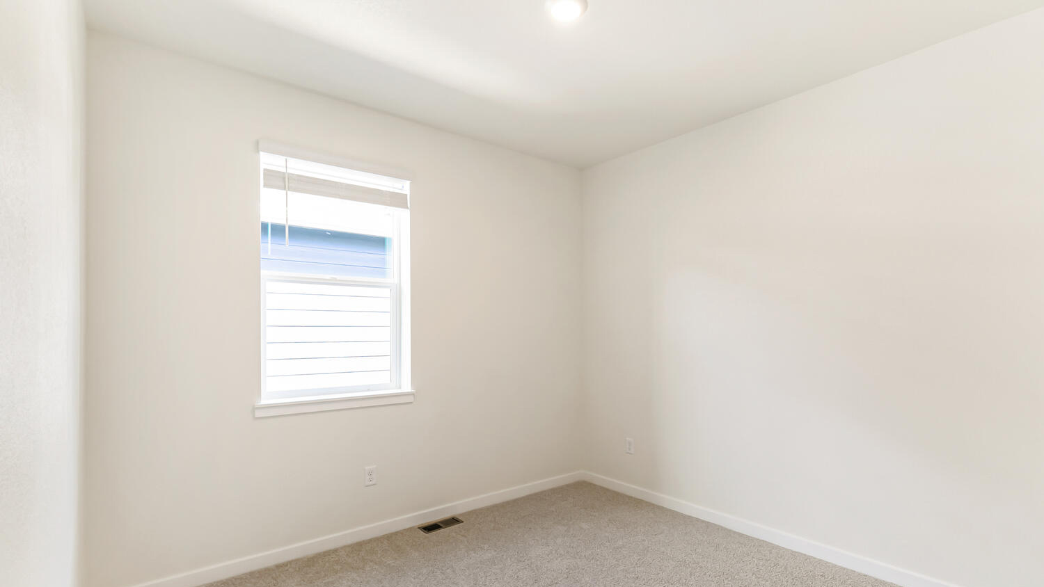 Secondary bedroom located near second bath with plush carpeting and energy-saving LED lighting