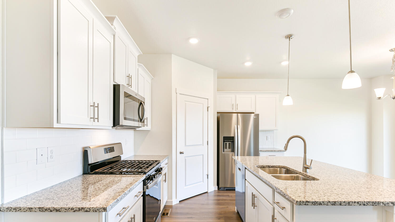 Side view of kitchen showing granite countertops and chrome fixtures