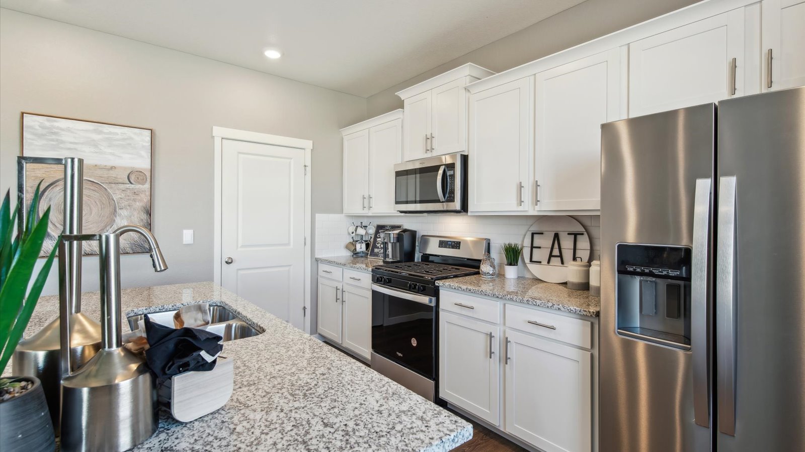 New stainless steel appliances at Settler's Crossing community new home
