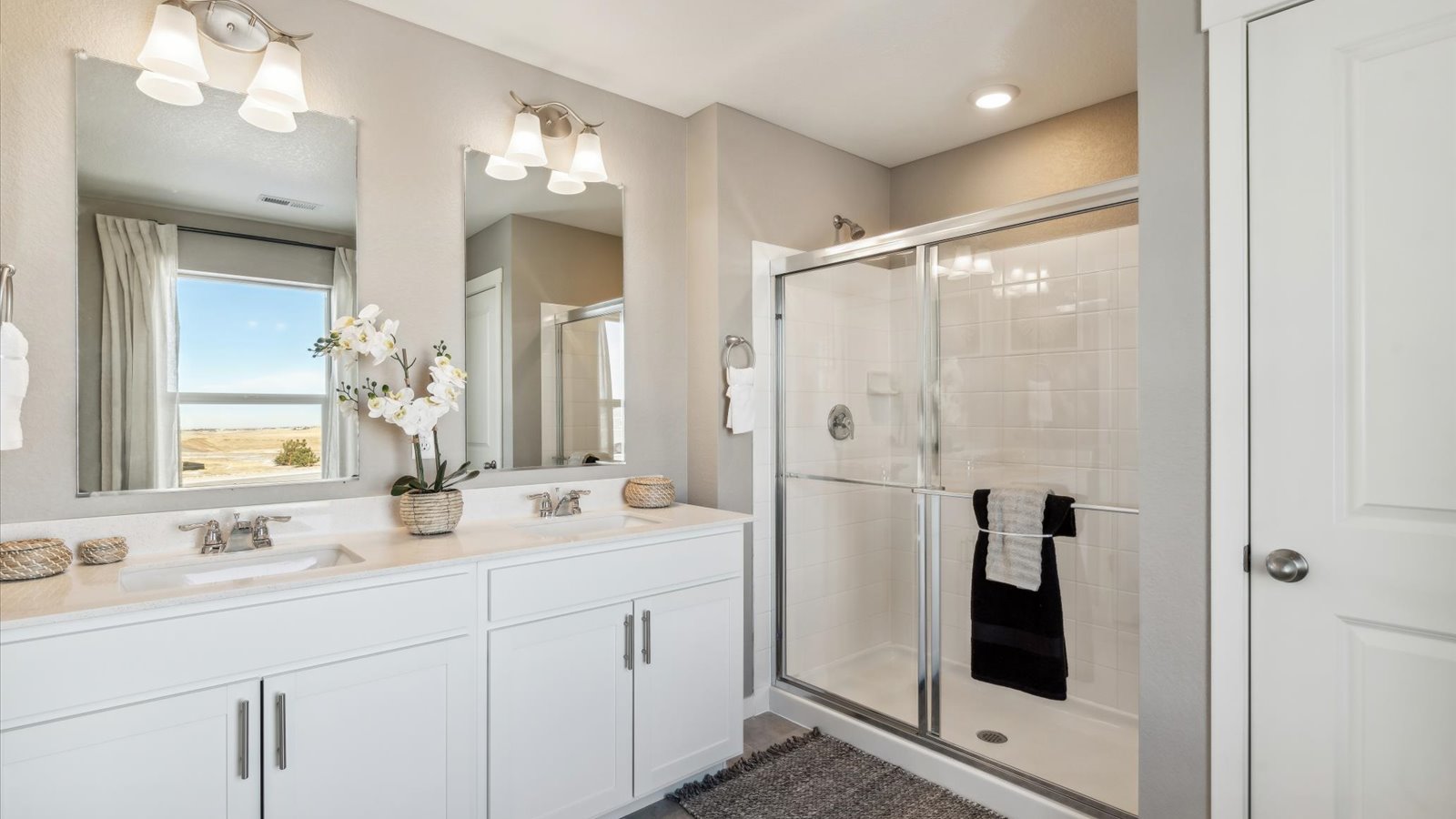 Private attached primary bathroom with dual vanity sink in new D.R. Horton home