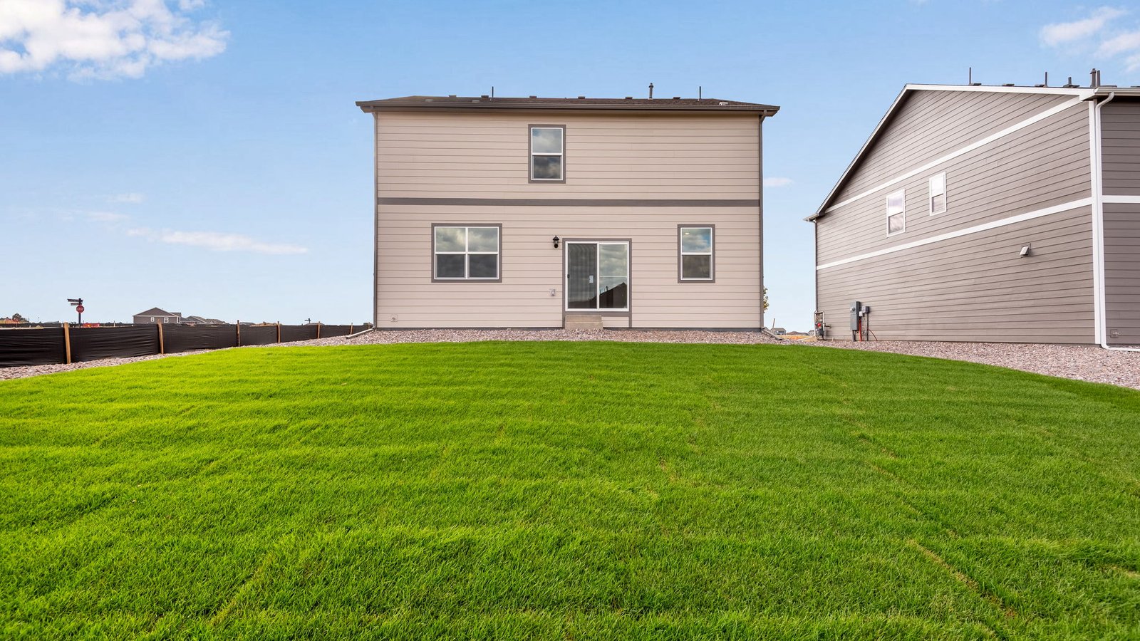 Backyard landscaping of two story home in Settlers Crossing community