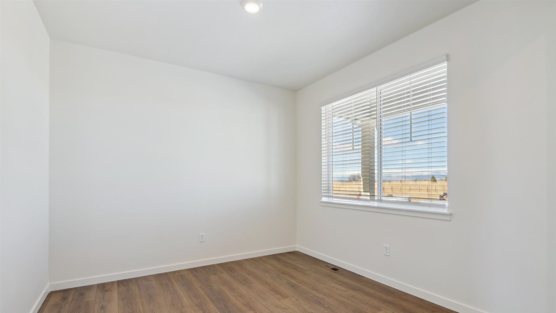 Study on main floor with large window located at front of home near entryway