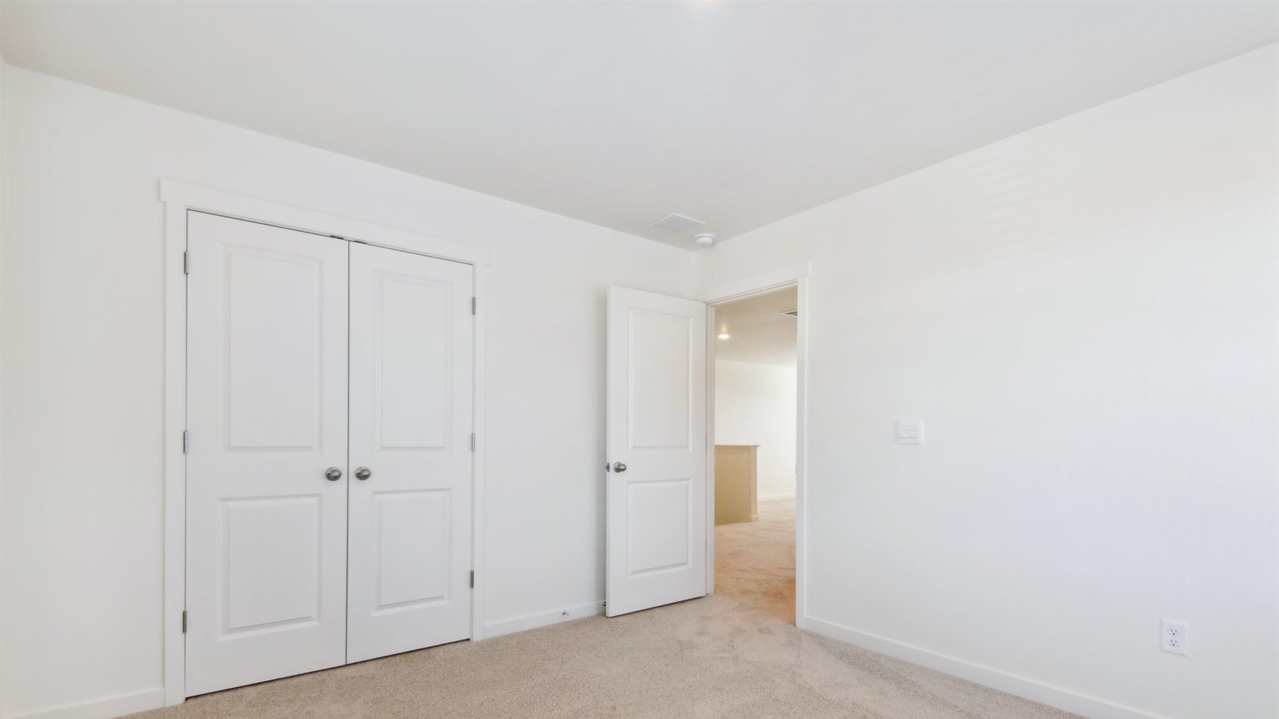 Additional bedroom adjacent to open loft space with double door closet