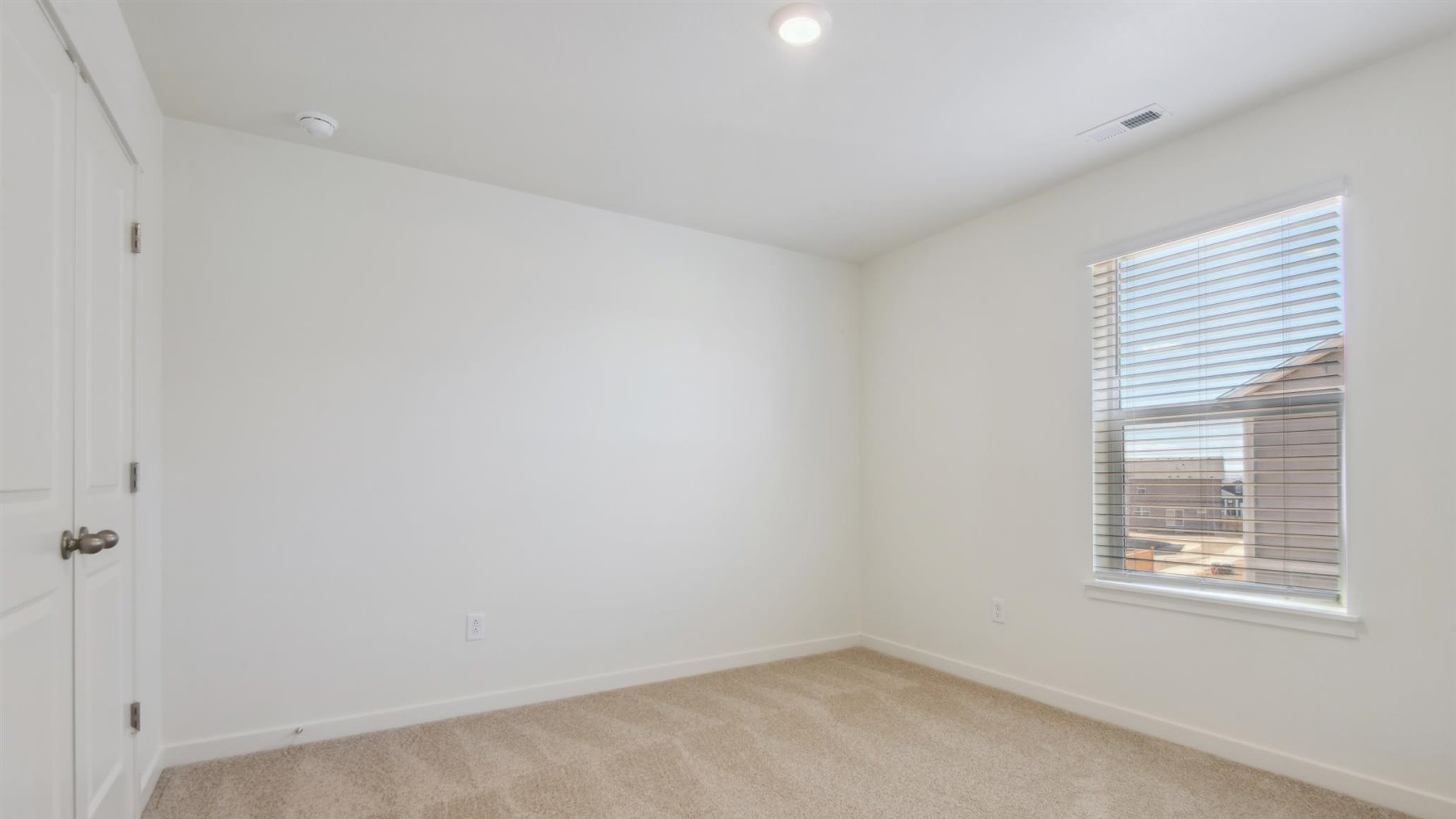 Another view of bedroom next to primary bedroom showing large window and LED lighting