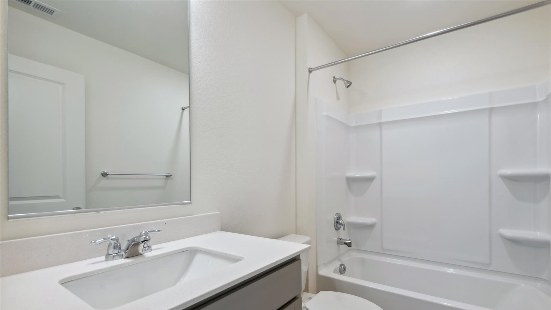 Secondary bathroom located between linen closet and secondary bedroom with shower/tub combo